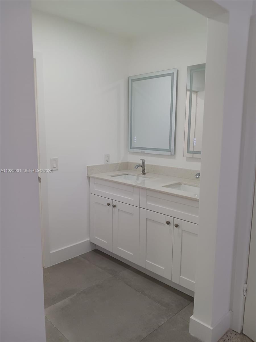 9228 Southwest 37th Street, Unit 9228 Miami, FL 33165 - Photo 22 of 25 a bathroom with a sink and a mirror