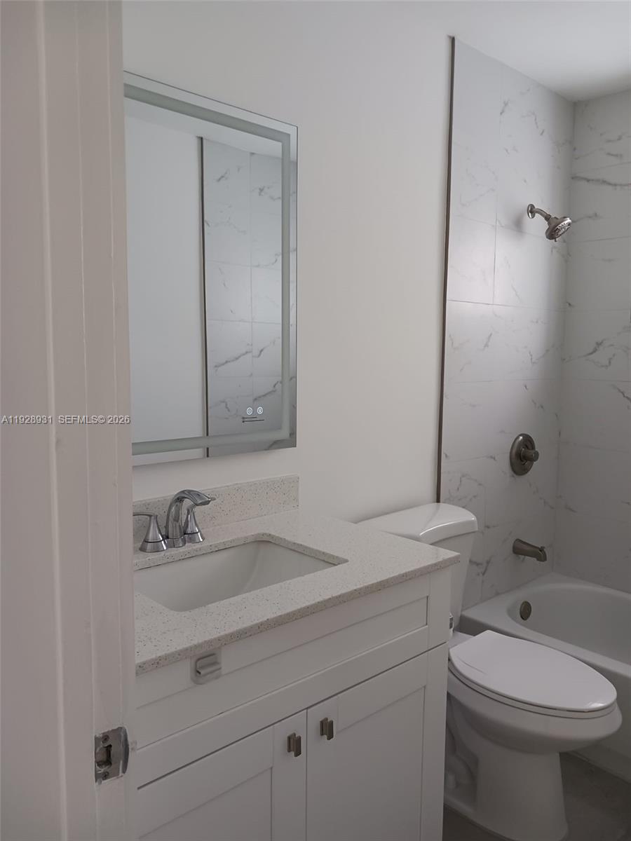 9228 Southwest 37th Street, Unit 9228 Miami, FL 33165 - Photo 23 of 25 a bathroom with a sink a toilet and shower