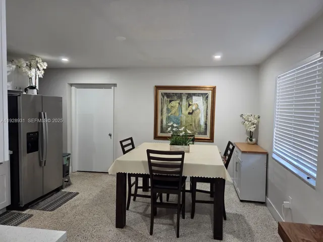 a dining room with furniture and window