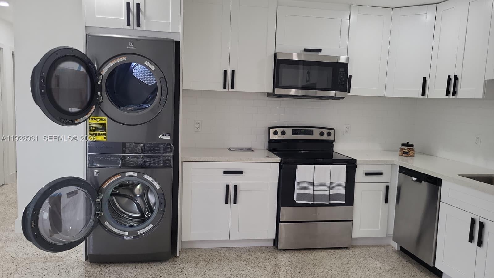 9228 Southwest 37th Street, Unit 9228 Miami, FL 33165 - Photo 6 of 27 a kitchen with a stove and a microwave