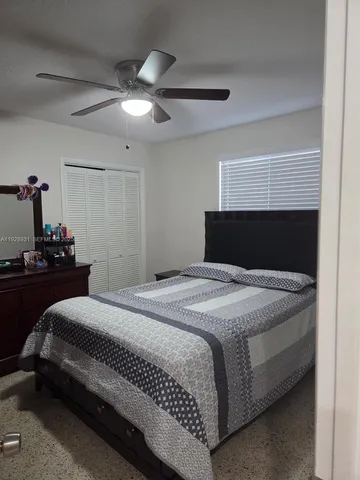 a bedroom with a bed and a mirror