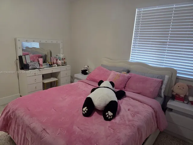 a bed room with a bed and a chair