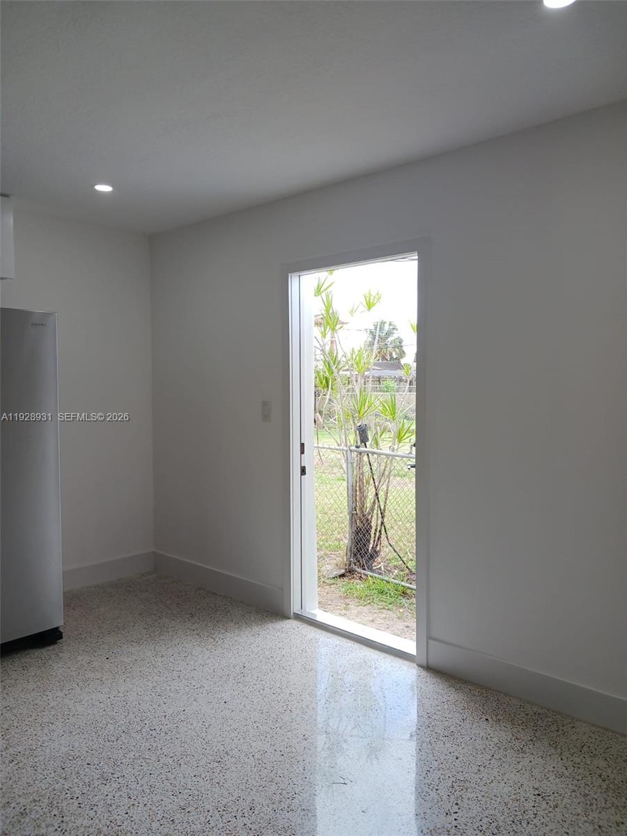9228 Southwest 37th Street, Unit 9228 Miami, FL 33165 - Photo 10 of 25 an empty room with outdoor view