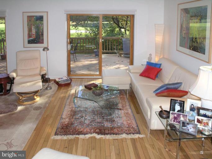 2023 Sarazen Place Reston, VA 20191 - Photo 15 of 30 a living room with furniture and a floor to ceiling window