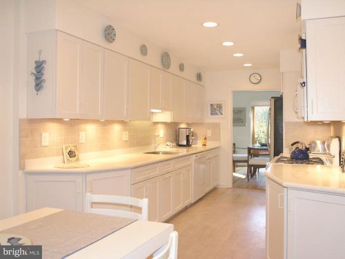 2023 Sarazen Place Reston, VA 20191 - Photo 18 of 30 a kitchen with a sink cabinets and window