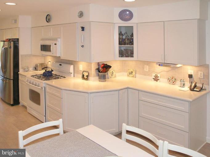 2023 Sarazen Place Reston, VA 20191 - Photo 19 of 30 a kitchen with a sink stove and refrigerator