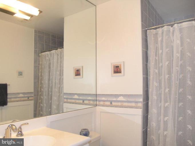 2023 Sarazen Place Reston, VA 20191 - Photo 28 of 30 a bathroom with a tub and shower