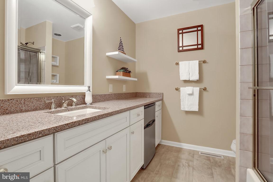 5711 Visitation Way Baltimore, MD 21210 - Photo 19 of 25 a bathroom with a granite countertop sink and a mirror