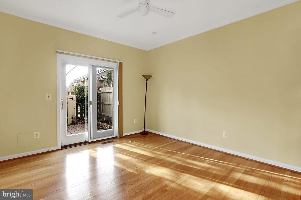 5711 Visitation Way Baltimore, MD 21210 - Photo 3 of 25 a view of an empty room with wooden floor and a window