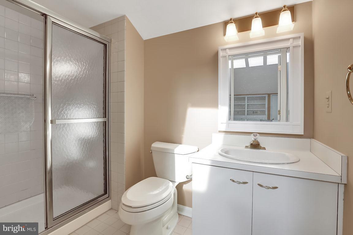 5711 Visitation Way Baltimore, MD 21210 - Photo 21 of 25 a bathroom with a granite countertop toilet sink and a mirror