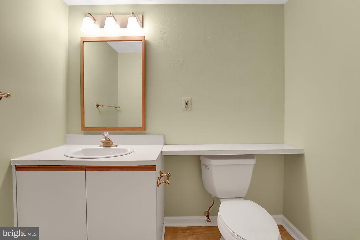 5711 Visitation Way Baltimore, MD 21210 - Photo 23 of 25 a bathroom with a toilet sink and mirror