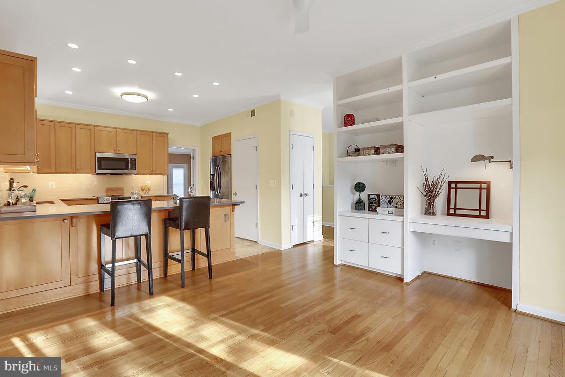 5711 Visitation Way Baltimore, MD 21210 - Photo 4 of 25 a open kitchen with white cabinets and wooden floor