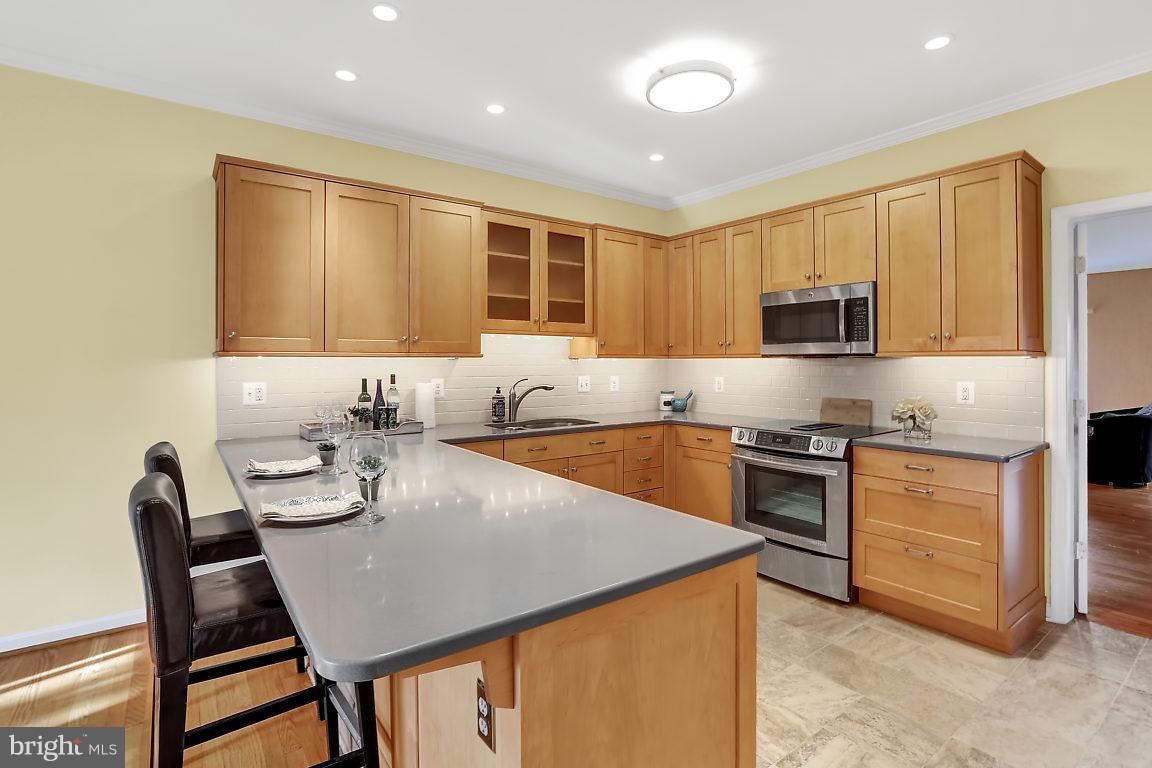 5711 Visitation Way Baltimore, MD 21210 - Photo 6 of 25 a kitchen with a stove a sink and a refrigerator