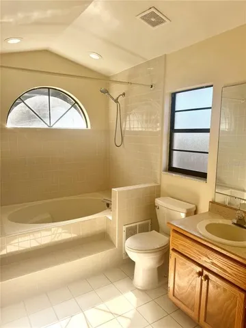 a bathroom with a toilet a sink and bathtub