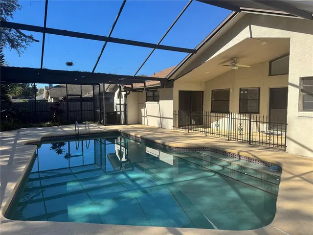 a view of a house with backyard porch and sitting area