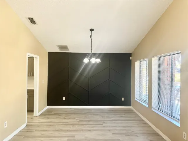 a view of a livingroom with a ceiling fan and window