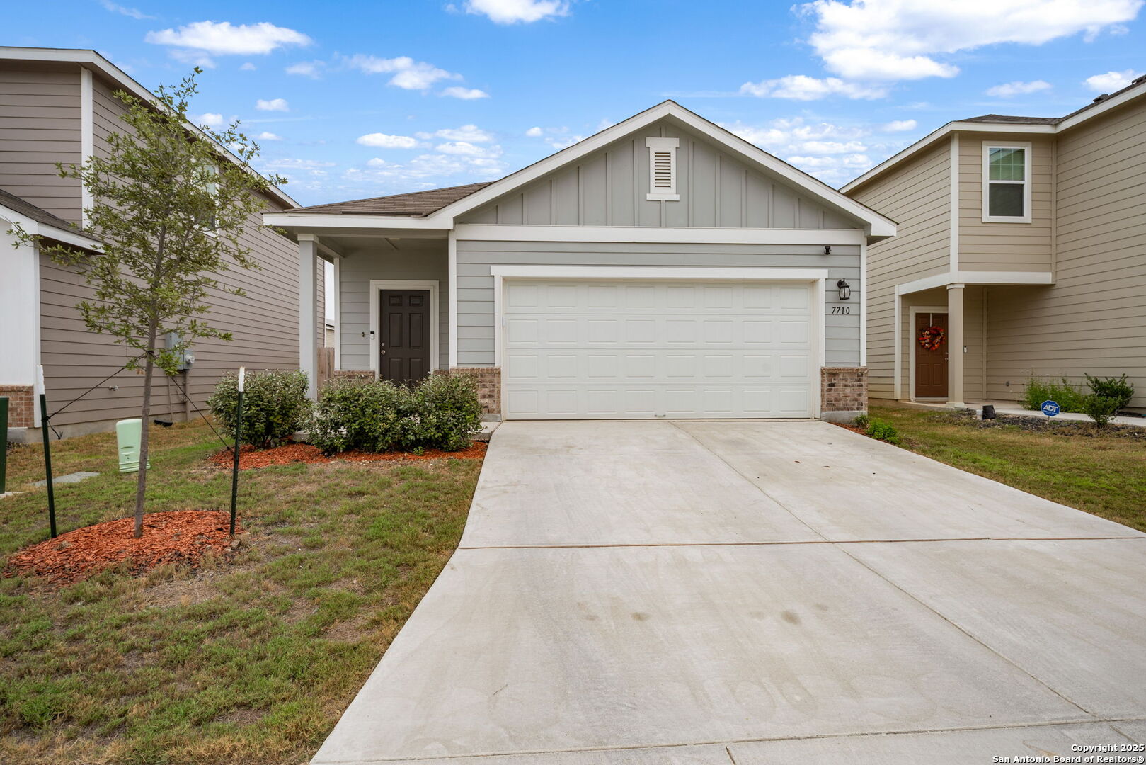 7710 Fern Hollow San Antonio, TX 78252 - Photo 1 of 26 a front view of a house with a yard and garage
