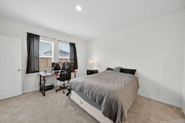 a bedroom with a bed and a large window