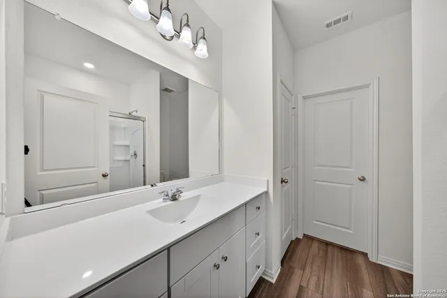 a bathroom with a double vanity sink mirror and double