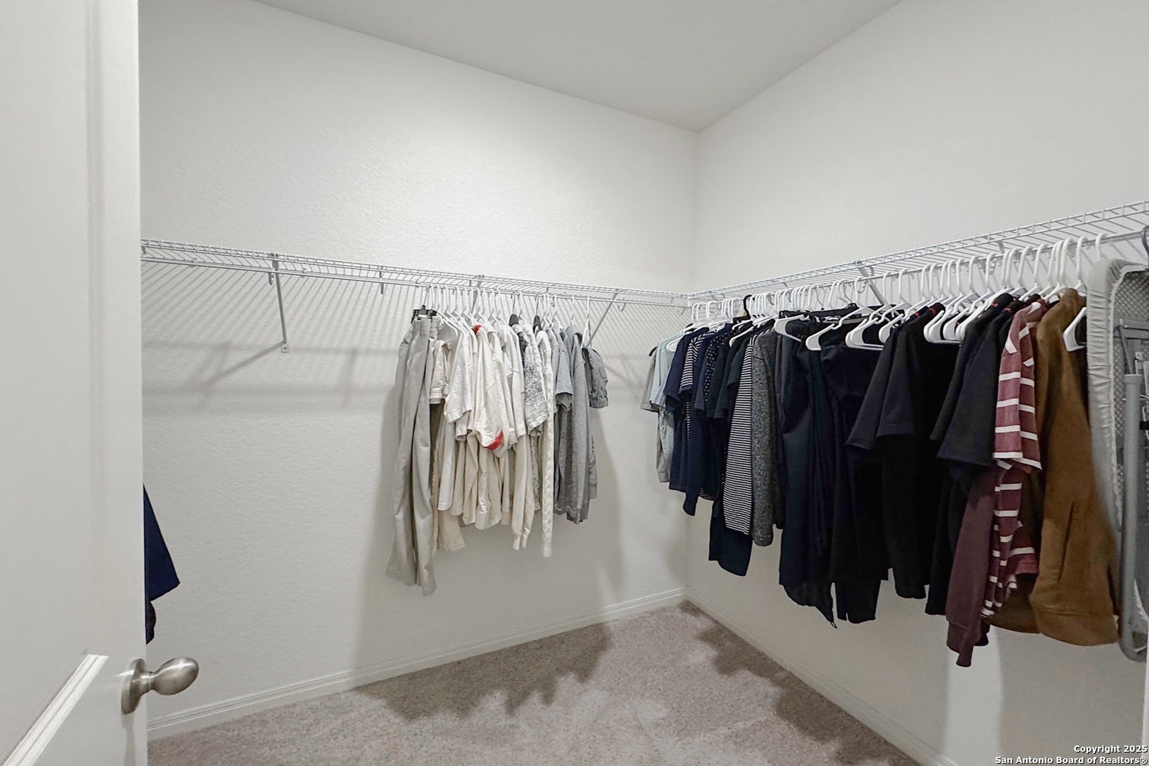 7710 Fern Hollow San Antonio, TX 78252 - Photo 15 of 26 a view of walk in closet with clothes and shoes