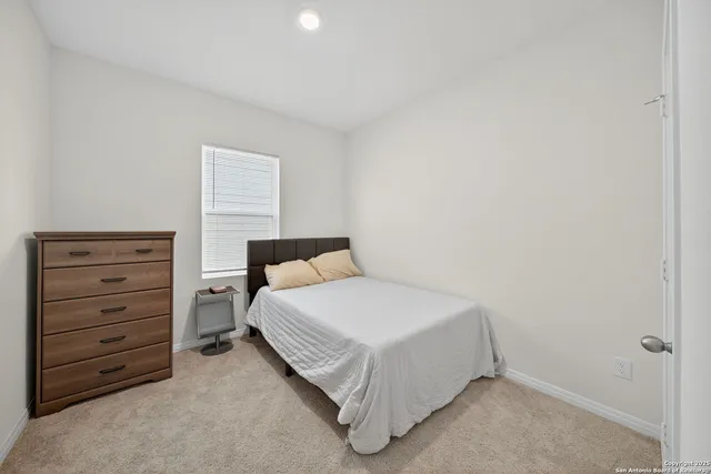 a bedroom with a bed and a dresser