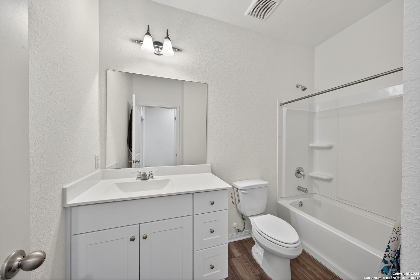 7710 Fern Hollow San Antonio, TX 78252 - Photo 18 of 26 a bathroom with a sink a toilet a mirror and shower