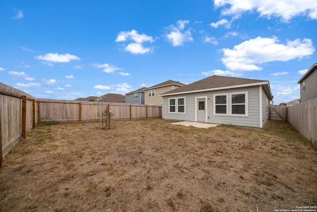 a view of a house with a backyard