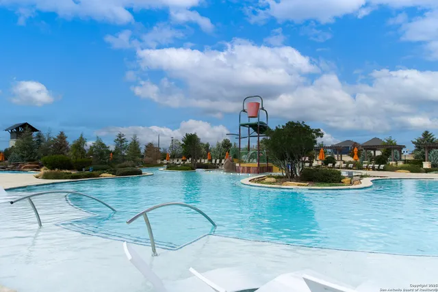 a view of a swimming pool with a table and chairs