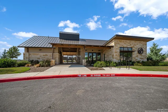 a front view of house with yard and white umbrellas