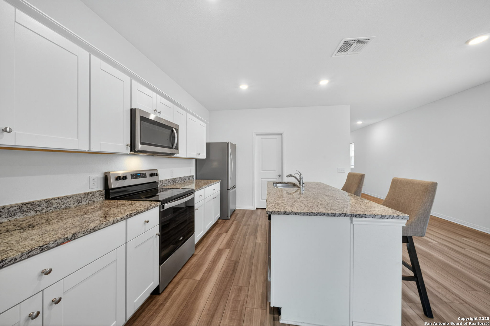 7710 Fern Hollow San Antonio, TX 78252 - Photo 8 of 26 a kitchen with stainless steel appliances granite countertop a sink dishwasher stove top oven and refrigerator