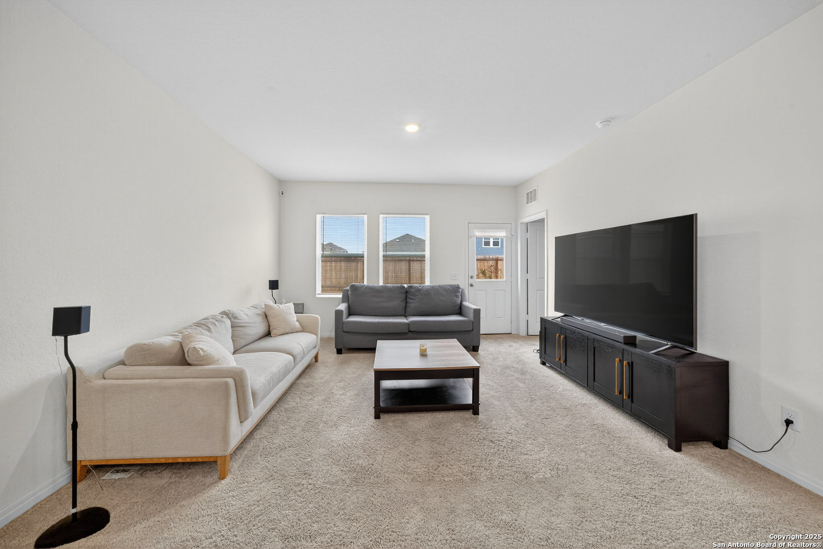 7710 Fern Hollow San Antonio, TX 78252 - Photo 9 of 26 a living room with furniture and a flat screen tv