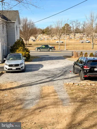 a view of a street with a car parked on the road