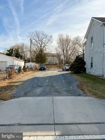 a view of a yard with cars