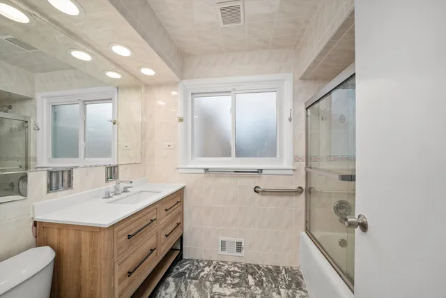 a bathroom with a double vanity sink a mirror and a shower