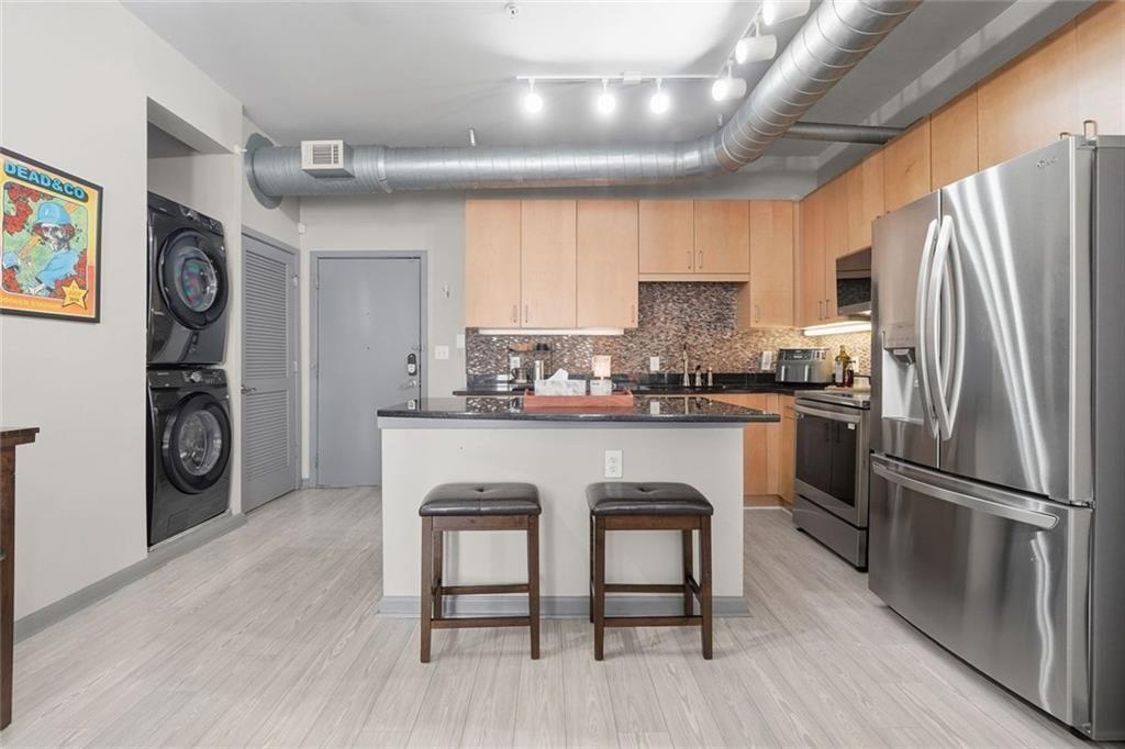 5300 Peachtree Road, Unit 2604 Atlanta, GA 30341 - Photo 11 of 39 a kitchen with granite countertop a refrigerator and a stove top oven