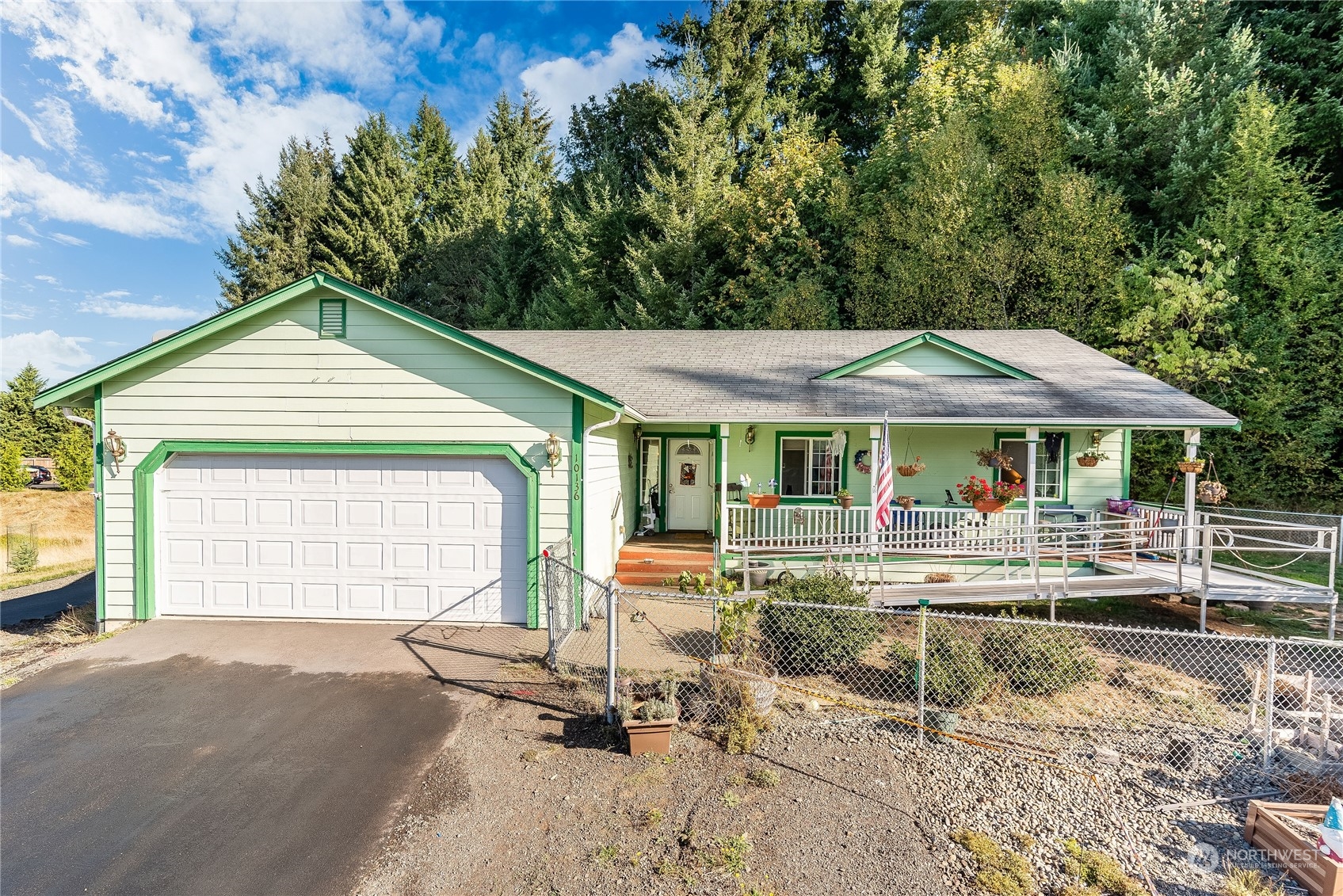 10136 Meadowside Lane Southwest Rochester, WA 98579 - Photo 1 of 32 a backyard of a house with yard table and chairs