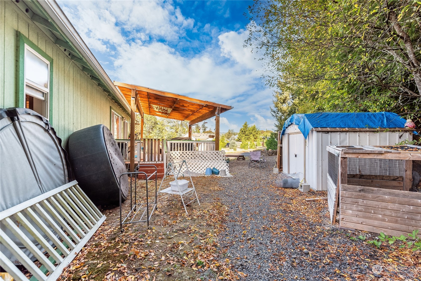 10136 Meadowside Lane Southwest Rochester, WA 98579 - Photo 26 of 32 a backyard of a house with table and chairs