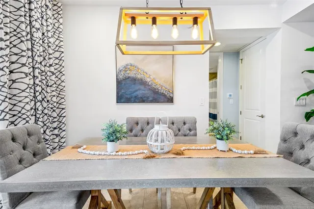 a spacious bedroom with a large bed and a chandelier