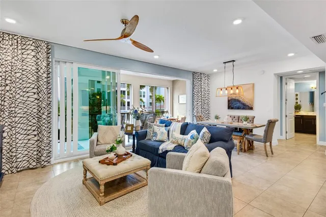 a living room with furniture a flat screen tv and a potted plant