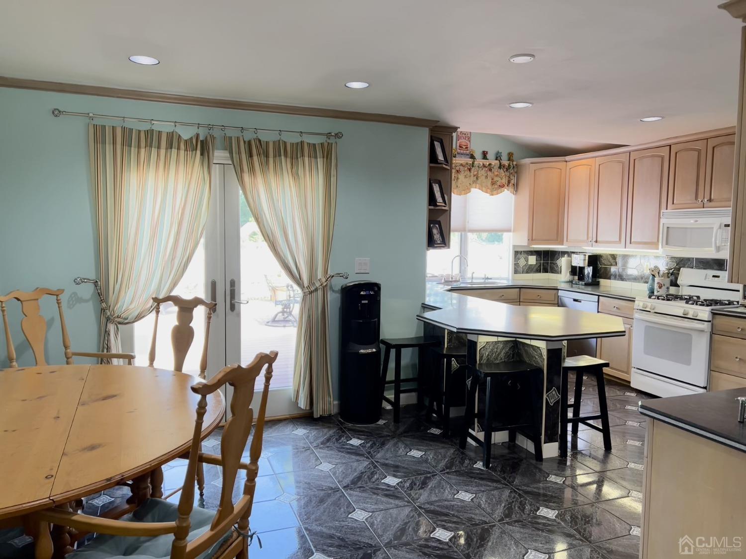 3 Barton Road Old Bridge, NJ 08857 - Photo 12 of 38 a kitchen with a table chairs stove and cabinets