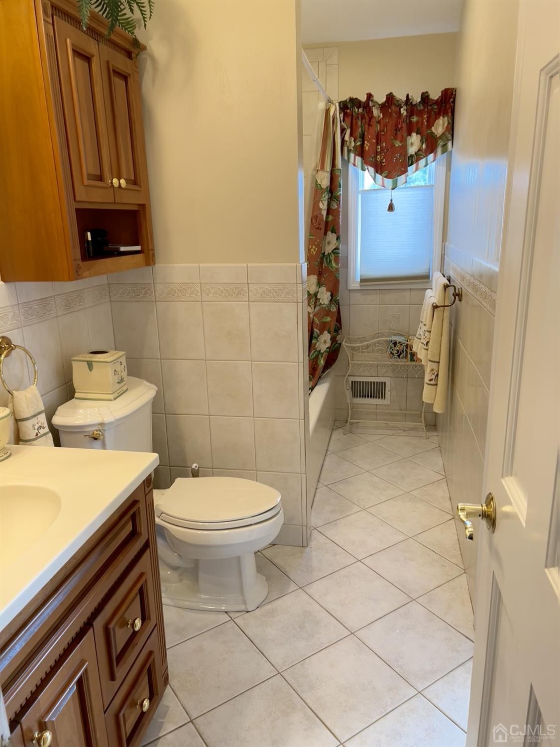 3 Barton Road Old Bridge, NJ 08857 - Photo 38 of 38 a bathroom with a toilet a sink and mirror