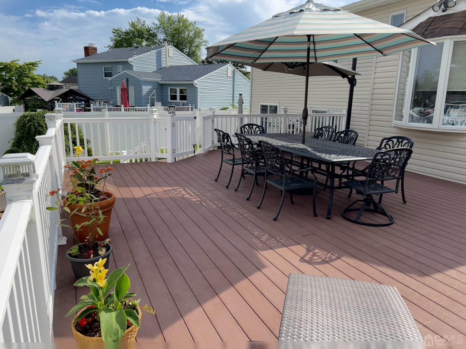 3 Barton Road Old Bridge, NJ 08857 - Photo 6 of 38 a view of a patio with table and chairs potted plants with wooden floor