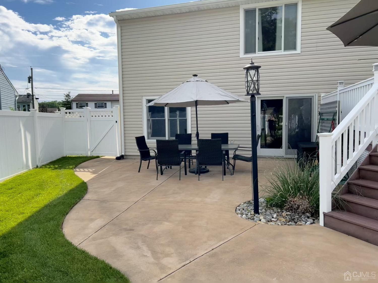 3 Barton Road Old Bridge, NJ 08857 - Photo 7 of 38 a patio with table and chairs and potted plants