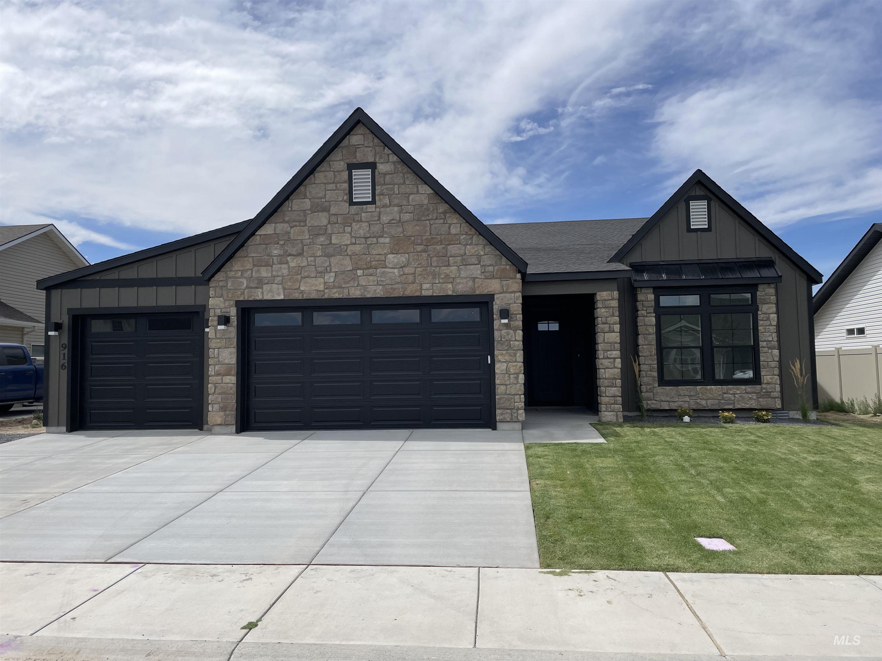 916 Kenbrook Loop Twin Falls, ID 83301 - Photo 1 of 30 View of front of house with board and batten siding, an attached garage, and stone siding