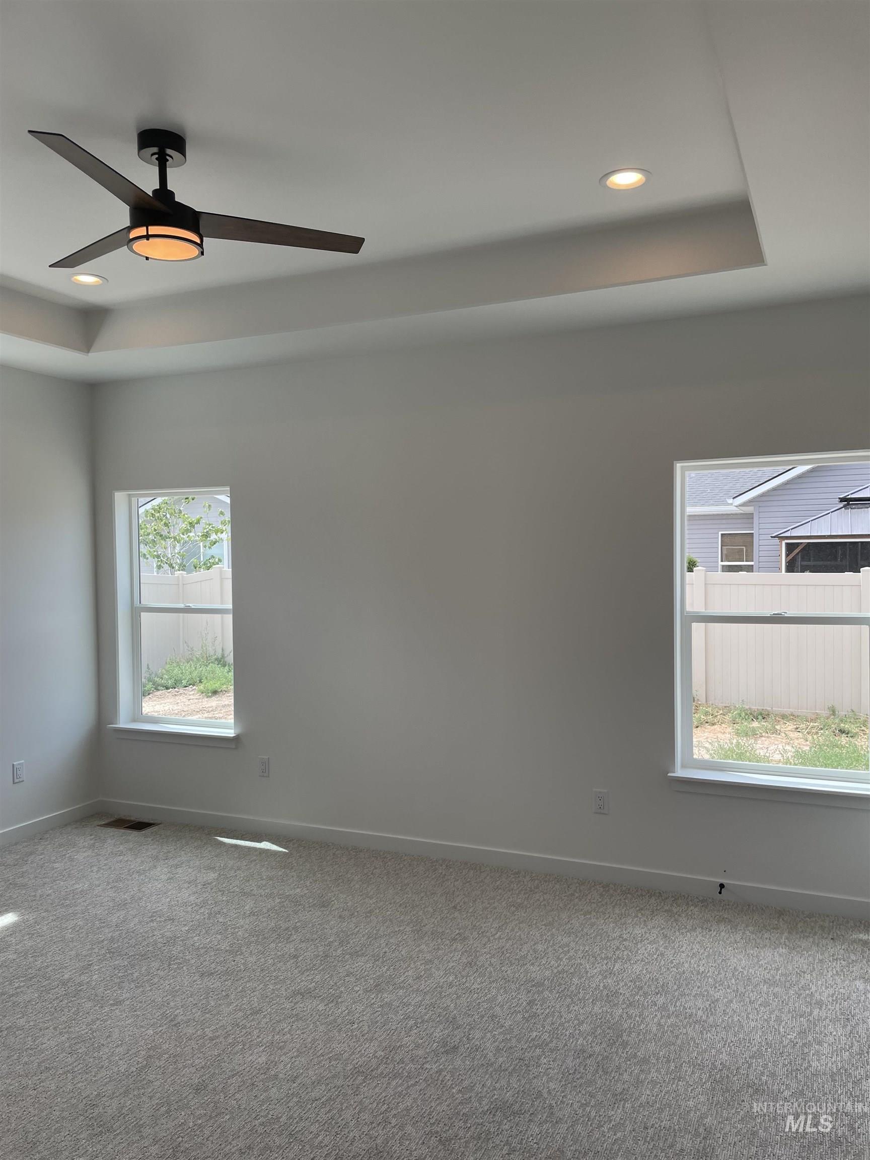 916 Kenbrook Loop Twin Falls, ID 83301 - Photo 16 of 30 Carpeted spare room with a tray ceiling, recessed lighting, and a ceiling fan