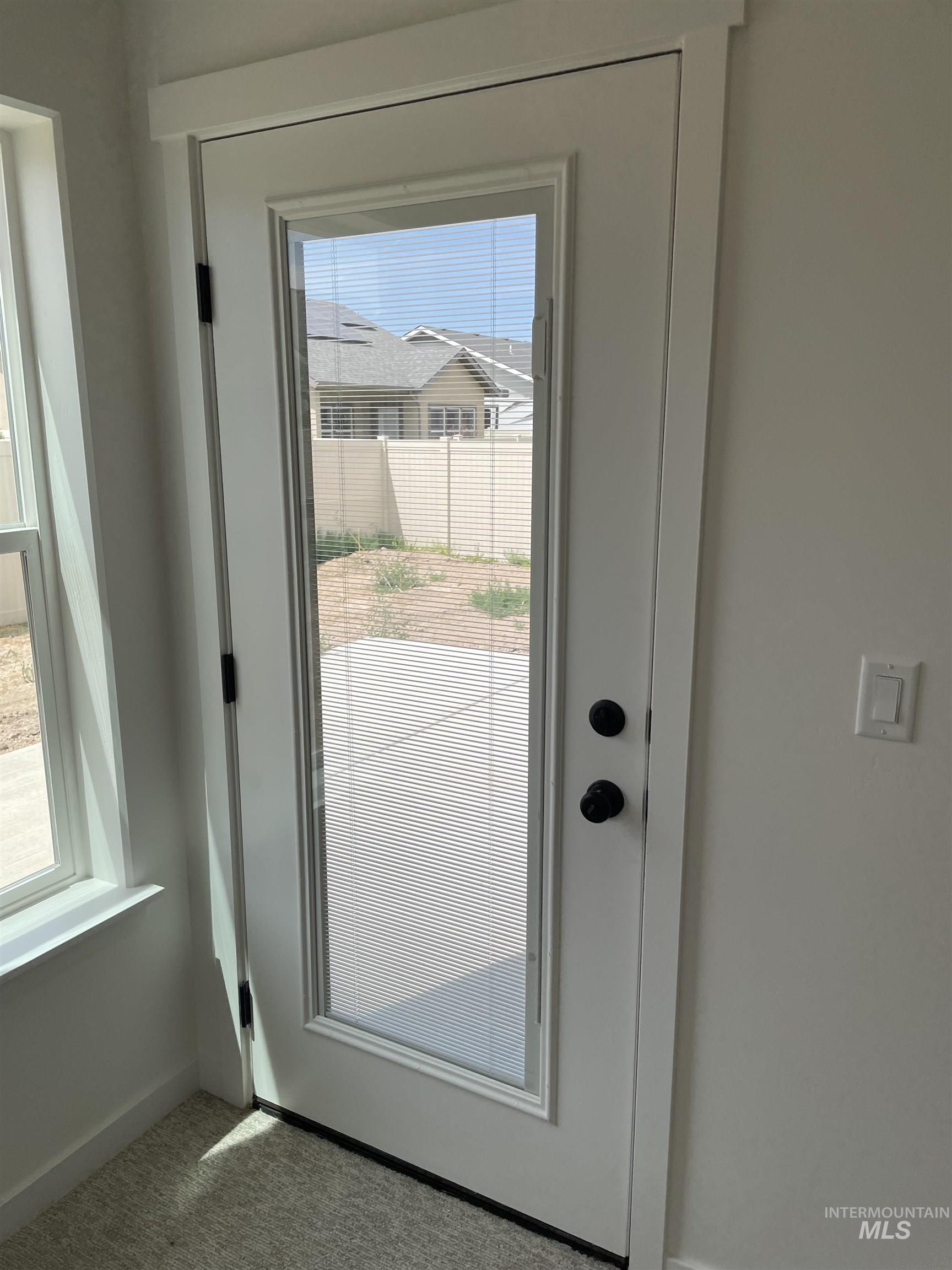 916 Kenbrook Loop Twin Falls, ID 83301 - Photo 27 of 30 Doorway to outside featuring carpet and baseboards