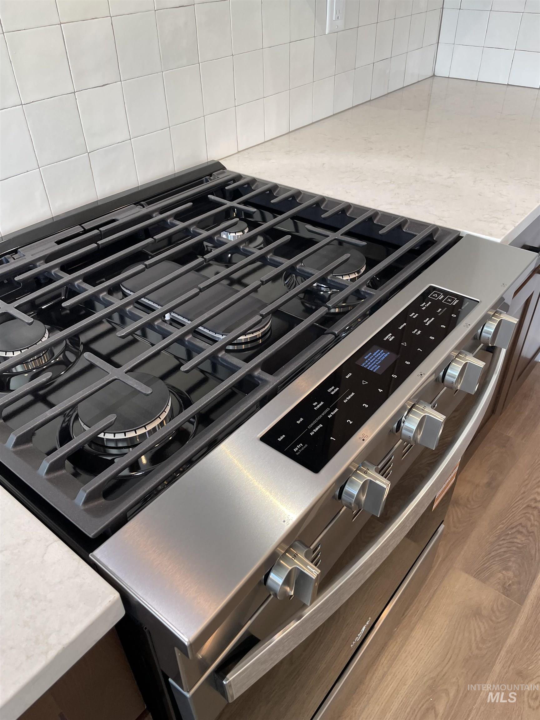 916 Kenbrook Loop Twin Falls, ID 83301 - Photo 6 of 30 Kitchen view of stainless steel gas stove and light stone counters