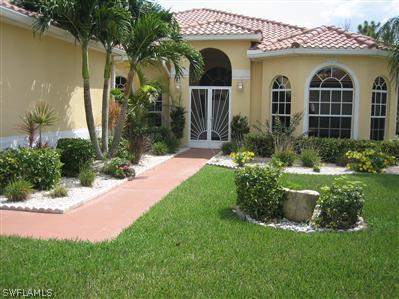 9010 West Ridge Court Fort Myers, FL 33912 - Photo 2 of 10 a front view of a house with a yard