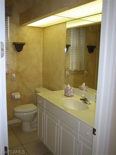 9010 West Ridge Court Fort Myers, FL 33912 - Photo 7 of 10 a bathroom with a sink and a mirror
