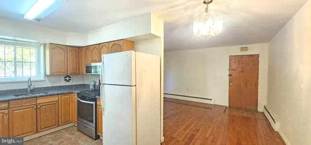 a white refrigerator freezer sitting inside of a kitchen